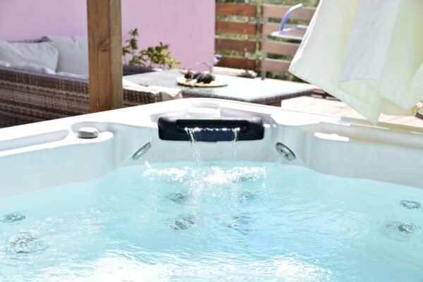 a pool with a chair and a table in the background