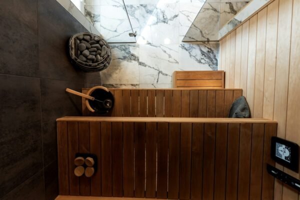 Wooden sauna benches with stones and bucket